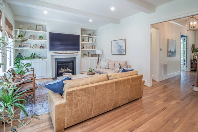 a%20white%20living%20room%20with%20wood%20flooring%20and%20built%20in%20entertainment%20system a%20white%20living%20room%20with%20wood%20flooring%20and%20built%20in%20entertainment%20system